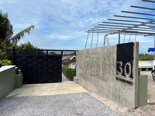 a gate to a house with the number on it at Thirty Degrees in February, Khao Tao, Hua Hin in Khao Tao