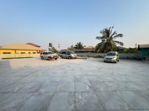 a group of cars parked in a parking lot at Anns Luxurious Apartments 3 in Accra