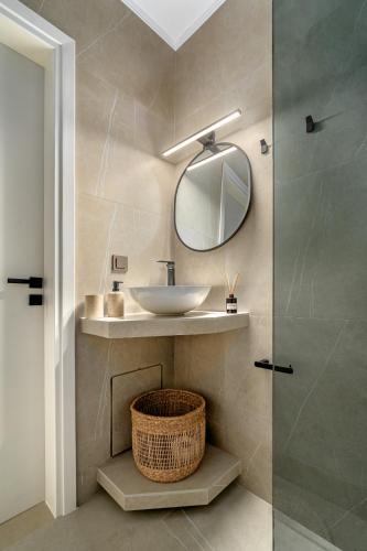 a bathroom with a sink and a mirror at Fly & Stay in Artemida