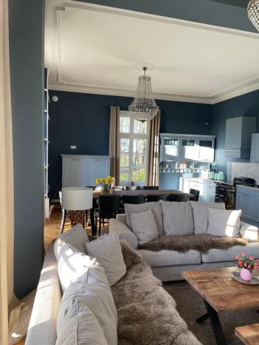 a living room with a couch and a table at Saniertes Gutshaus mit Komfort und privater Sauna in Neu Gaarz
