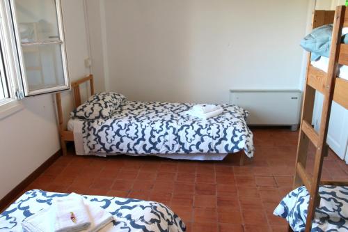 a small room with two beds and a staircase at Ostello Dei Concari in Governolo