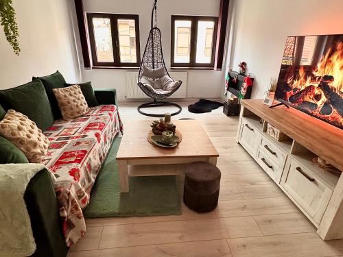 a living room with a couch and a table at Home central apartment Sibiu in Sibiu