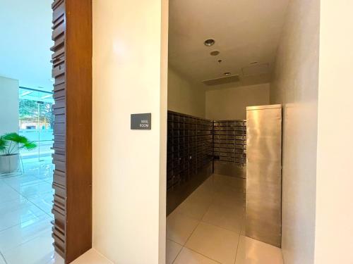 a hallway with a elevator in a building at Abreeza Place Cozy Condo in Davao City