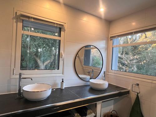 a bathroom with two sinks and a mirror at Villa Sand Golf by Carlon Luxury Rentals in Seignosse