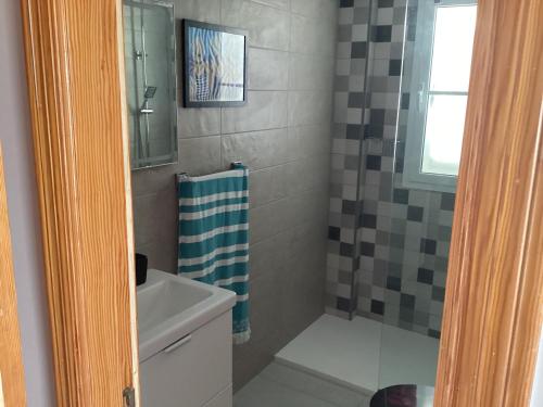a small bathroom with a shower and a sink at Mar&sun Casa Florida in Puerto del Carmen