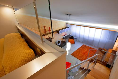 an overhead view of a living room with a yellow couch at Le Onde Resort in Viterbo