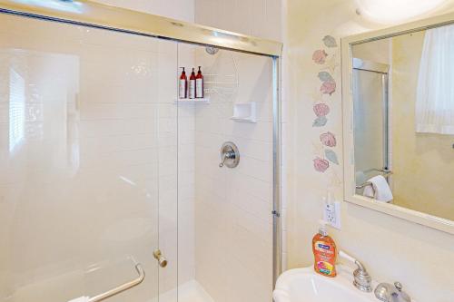 a bathroom with a shower and a sink at Oceanfront Dream in Cayucos
