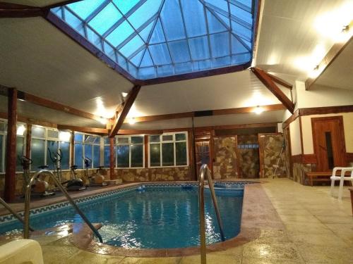 a swimming pool with a skylight in a house at Aldea Aliwen in Trevelin