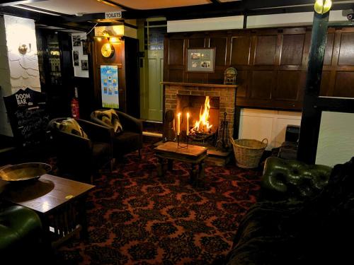 a living room with a fireplace and a table with candles at Anchor's Drop in Blue Anchor