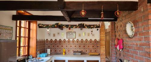 a kitchen with a brick wall with christmas decorations at Casa Lalla natura e relax in Cusano Mutri
