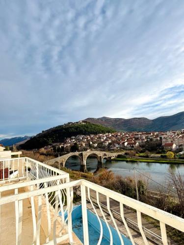 a bridge over a river next to a city at Apartman VITO in Trebinje