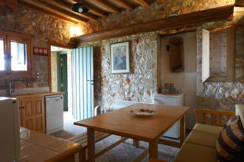 a kitchen with a wooden table in a room at SKYROS REFUGE in Skiros