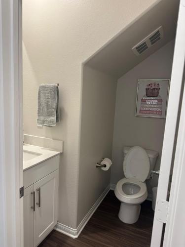 a small bathroom with a toilet and a sink at Gated Upland Home 3b 3 bath in Upland