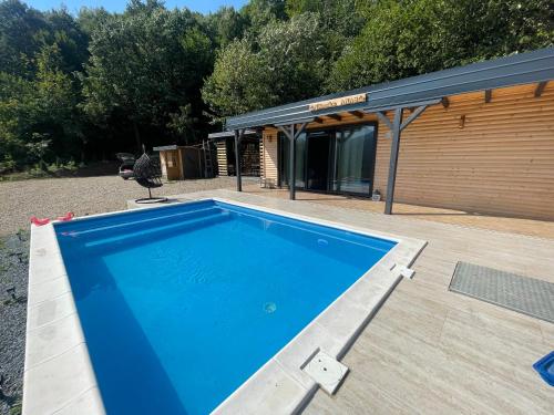 a swimming pool in front of a house at Vikendica Anas in Tuzla