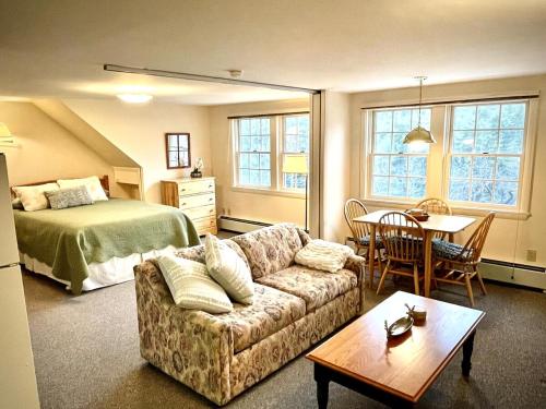 a living room with a couch and a bed and a table at Peaceful Mtn Studio Pet-friendly in Woodstock