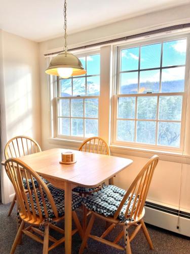 a dining room with a wooden table and chairs at Peaceful Mtn Studio Pet-friendly in Woodstock