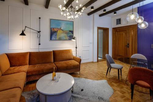 a living room with a couch and a table at JEZERSKA RESIDENCE Palić in Palić