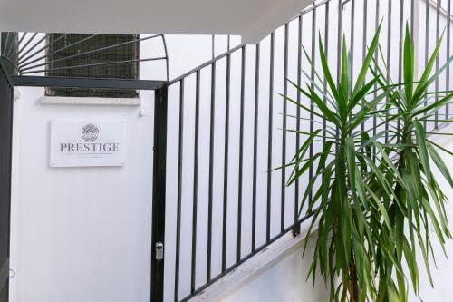 a white door with a sign on it next to a plant at Hotelleria Prestige in Rome