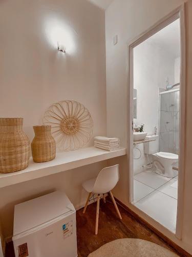 a white bathroom with a sink and a toilet at Pousada Flores do Farol in Salvador