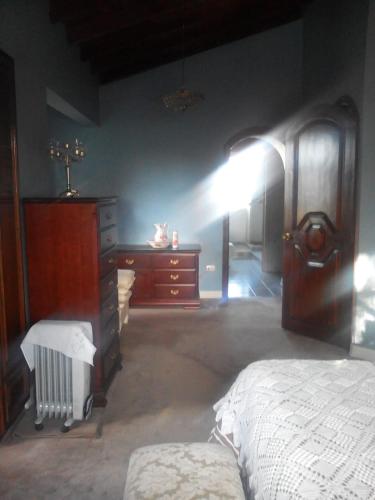 a bedroom with a bed and a dresser and a dresser at Hostal Saint Mary´s Tababela in Tababela