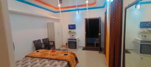 a room with a bed and a mirror in it at Marigold Homestay in coorg in Madikeri