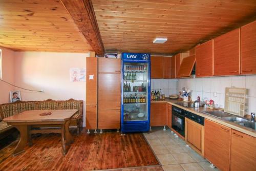 a kitchen with a refrigerator and a table in it at Country Villa MMMM-3-Camp Scepanovic in Mojkovac