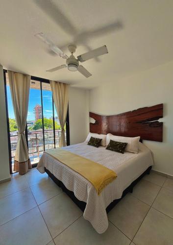 a bedroom with a bed and a ceiling fan at Studio for Tourism or Business Trip in Corrientes