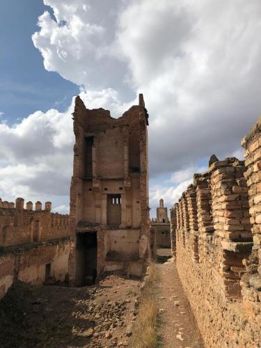an old building with a dirt road in front of it at Kasbah Oum Rabia in Boulaouane