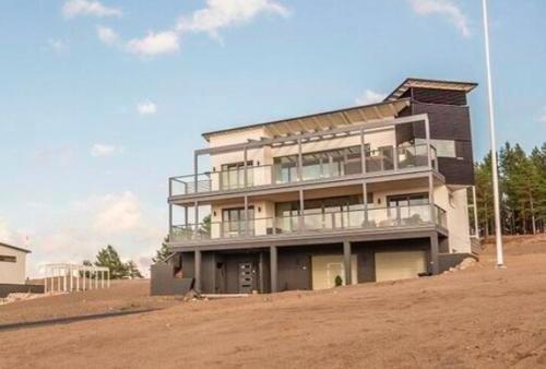 a large building on top of a dirt field at Luxury Privat Villa Merellä in Kalajoki