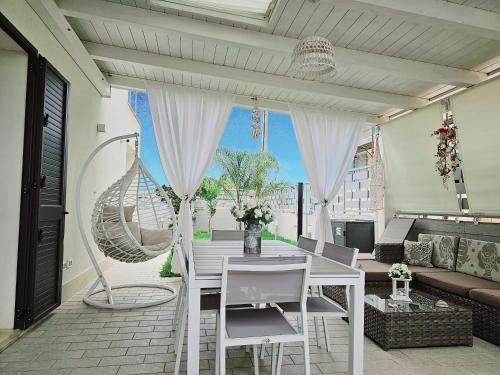a living room with a white table and chairs at Villa Solemar Holidays in Avola