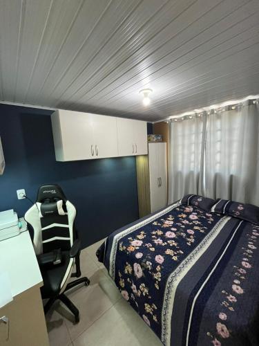 a bedroom with a bed and a chair in it at Casa familiar rua 13 maio número 1639 in Rosário do Sul