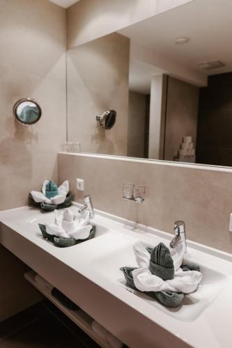 a bathroom with three sinks and a mirror at Haus Anemone in Serfaus