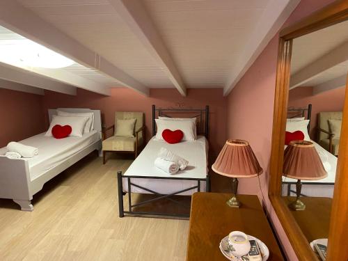 a room with two beds with red hearts on them at HOUSE MINA Corfu in Ýpsos