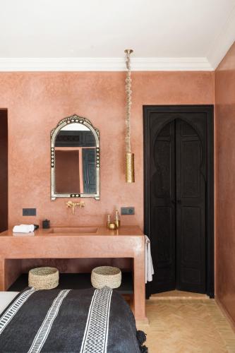 a bathroom with a sink and a mirror at Riad Dar Acsameda & Spa in Marrakech