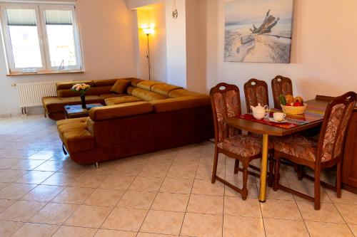 a living room with a couch and a table at Apartament Julia przy plaży in Międzyzdroje