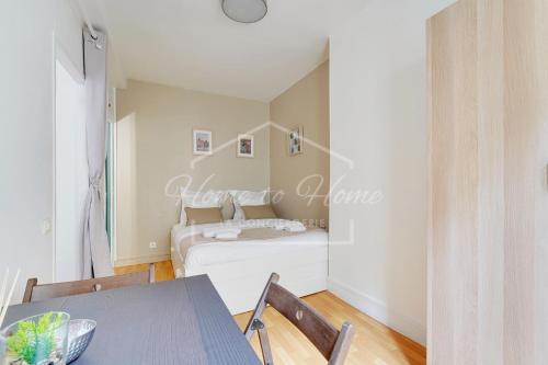 une chambre avec un lit, une table et des chaises dans l'établissement Charmant appartement 23m2 à Pantin, à Pantin