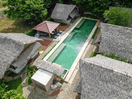 an overhead view of a swimming pool between two roofs at LA QUEBRADA ECO LODGE Hotel Boutique in Potrero