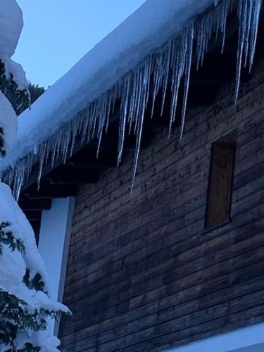 a building with icicles on the roof of it at Appartment Lori in Wald am Arlberg