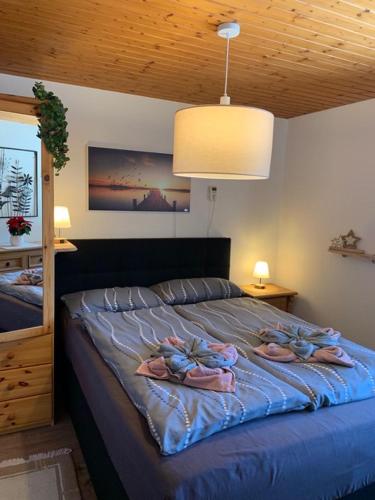 a bedroom with a bed with slippers on it at Appartment Lori in Wald am Arlberg