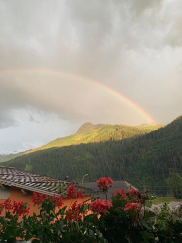 a rainbow in the sky over a mountain at Appartment Lori in Wald am Arlberg