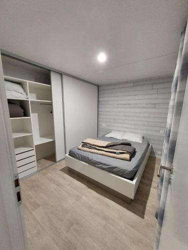 une chambre avec un lit dans une pièce dans l'établissement chalet de 1 a 7 personnes, à Hermanville-sur-Mer