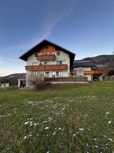 a large house with a field in front of it at Ferienhof Oberer Riesner in Tiefgraben