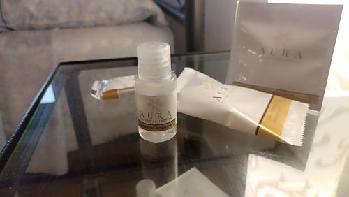 a bottle of moisturizing oil sitting on a glass table at Carloforte Appartamento con Vista IUN R2015 in Carloforte