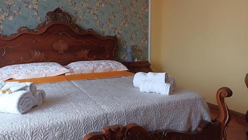 a bedroom with a bed with towels on it at Carloforte Appartamento con Vista IUN R2015 in Carloforte