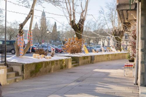 a sidewalk with a row of cactusitures on it at Casa Luna Rural Con Piscina y Jardín in Ourense