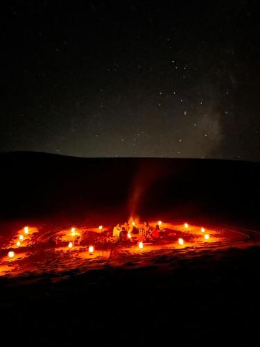 a city lit up at night with lights at Gambi Camp in Hassilabied