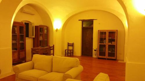 a living room with a couch in a room with arches at Posta Santa Croce in Bisceglie