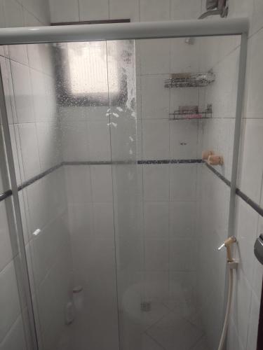 a shower with a glass door in a bathroom at Pousada L'étage in Búzios