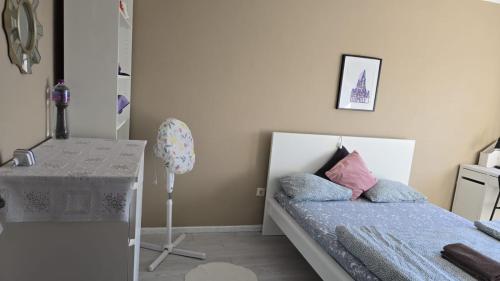 a small bedroom with a bed and a table at Quarto familiar com cama de casal apenas para casais e raparigas Não há homens solteiro Family room with double bed for couples and girls only No individual men allows with private washroom but in hall way in Braga