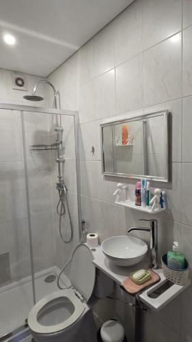 a bathroom with a shower and a toilet and a sink at Quarto familiar com cama de casal apenas para casais e raparigas Não há homens solteiro Family room with double bed for couples and girls only No individual men allows with private washroom but in hall way in Braga